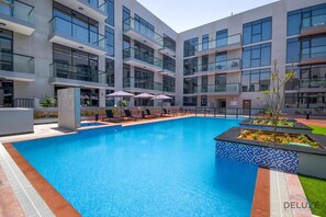 Pool - Modern Loft-Style Studio at Aria Residence, JVC by Deluxe Holiday Homes (Dubai)