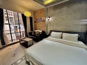 Junior Suite, City View | Living area | 50-inch flat-screen TV with cable channels