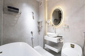 Junior suite, uitzicht op stad | Badkamer | Gratis toiletartikelen, pantoffels, zeep, shampoo