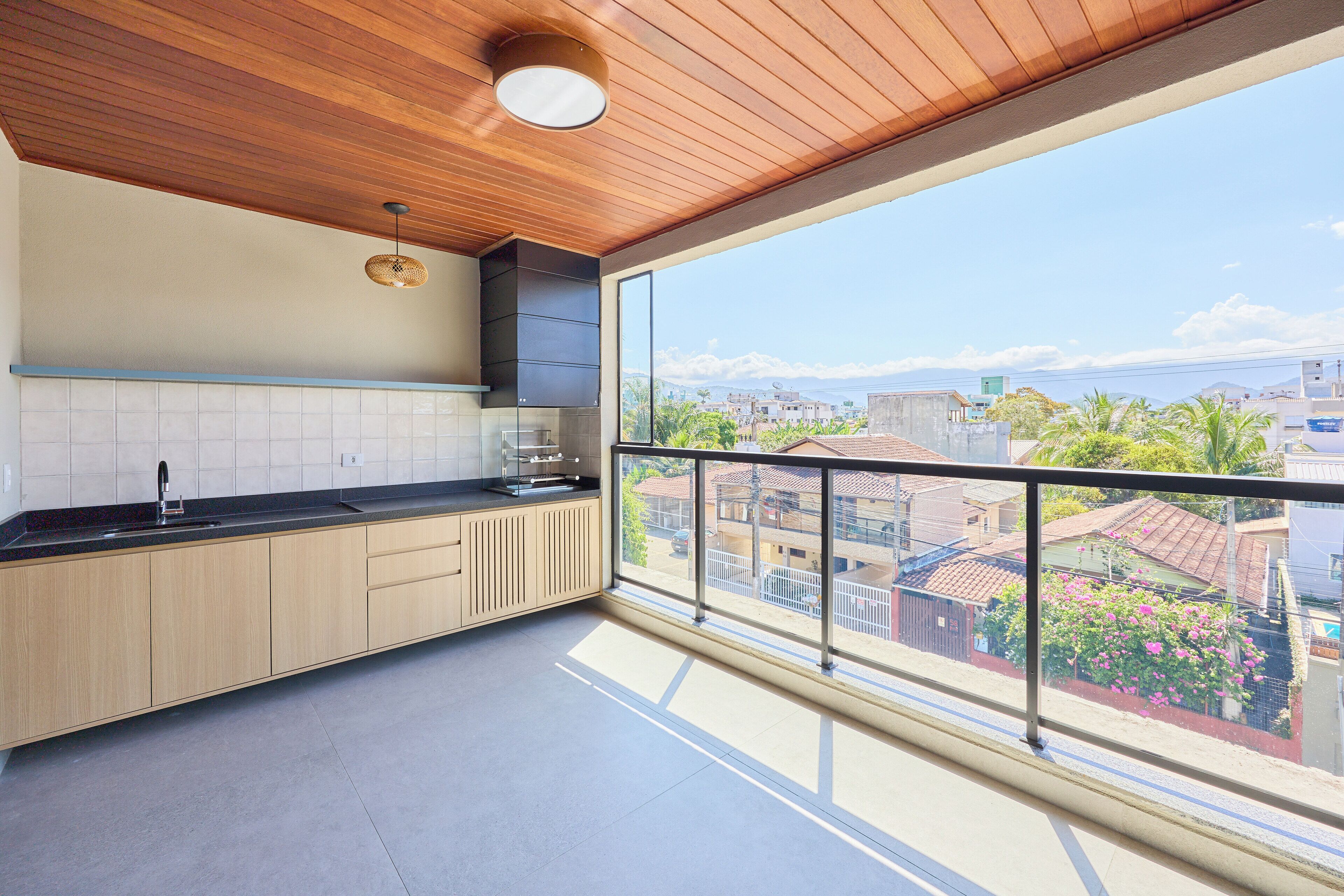 A modern kitchen with a large window overlooking a cityscape.
