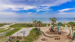 A beachside playground with a slide, swings, and a small shelter. - Ocean Lakes A9 – Huge Decks, Swings, and the Beach Just Steps Away! (Myrtle Beach)