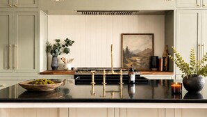 A kitchen with a black countertop, white cabinets, and three gold stools. - Luxury Golf Suncadia Retreat- Hot Tub + Sleeps 20 (Cle Elum)