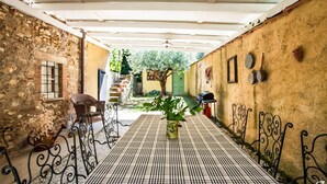 A covered outdoor corridor with a checkered floor, stone walls, and metal railings. - Pet friendly home in Camaiore (Camaiore)
