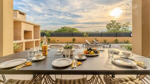 An outdoor dining area with a table set for two, a bottle of juice, and a fruit plate. - Lovely home in Jovici (Jovici)