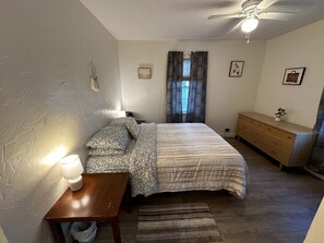 2 habitaciones, escritorio y tabla de planchar con plancha