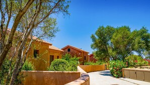 A pathway leading to a building with a tiled roof, surrounded by greenery and trees. - Relax at Villa Rhea, just a short walk from the beautiful Ai Helis Beach (Svoronata)