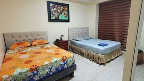 Un dormitorio con dos camas, una mesita de noche, un cuadro enmarcado en la pared y una ventana con persianas.