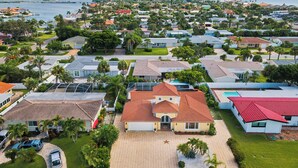 A residential area with houses, a marina, and a view of the ocean.