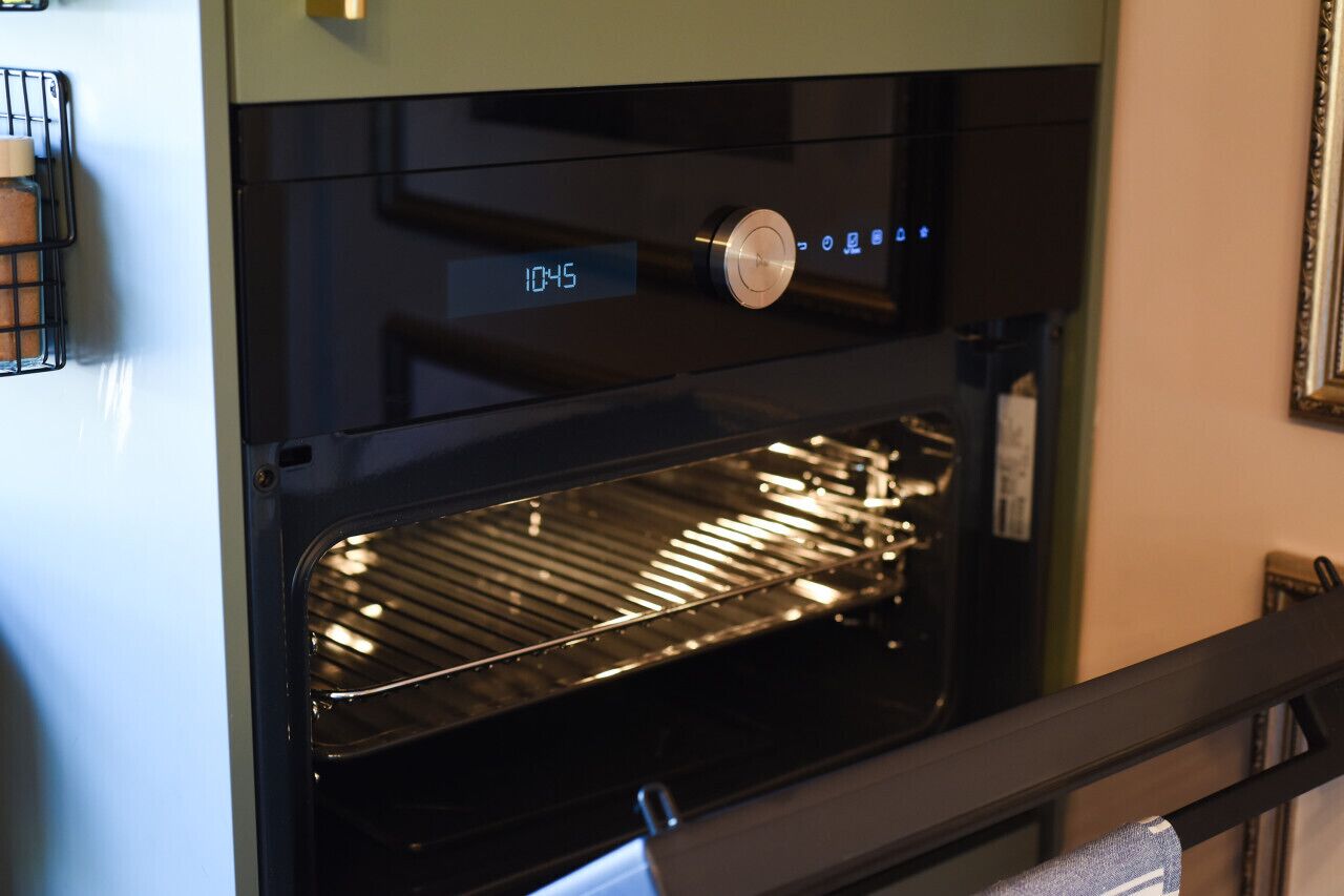 An oven with a digital clock displaying 10:45.