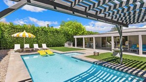 A swimming pool with lounge chairs, a pergola, and a covered patio area. - High Style Bohemian Zen Retreat, Saltwater Pool (Cathedral City)