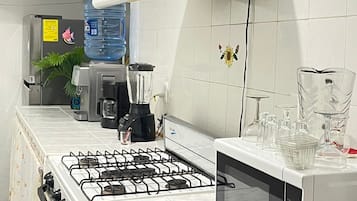 Fridge, microwave, coffee/tea maker, cookware/dishes/utensils