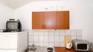 Fridge, microwave, stovetop, dining tables