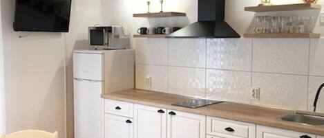 Fridge, microwave, stovetop, dining tables