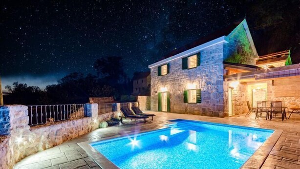 A stone building with a swimming pool, outdoor seating, and a starry night sky. - Holiday Home Rustic - Two Bedroom Holiday Home with Private Pool (Crivac)