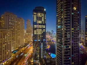 A high-rise urban area with tall buildings, a river, and a bridge.