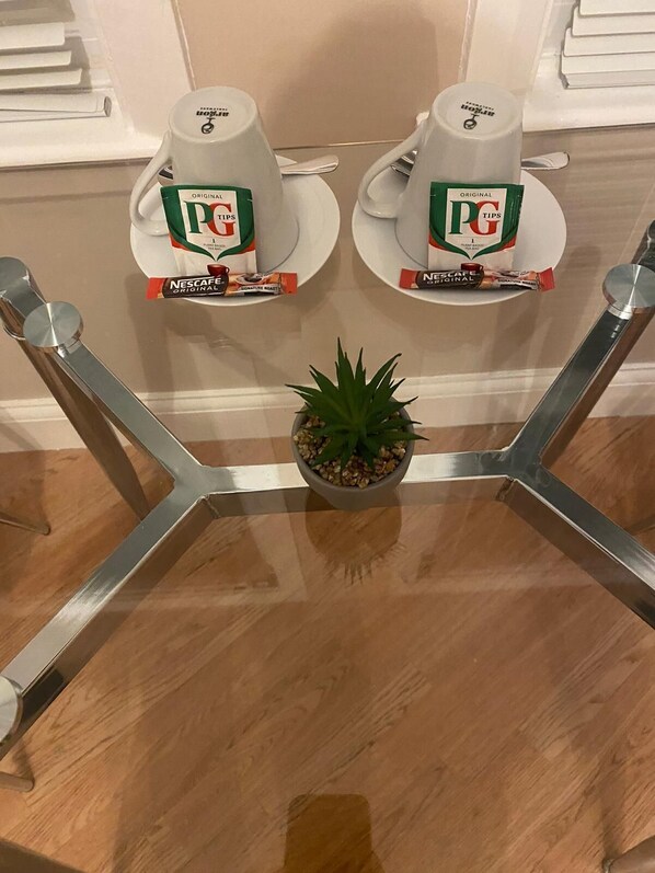 A kitchen counter with two Nescafe Original Signature Roast coffee makers and a small potted plant. - Studio in the Heart of Walthamstow Village (London)