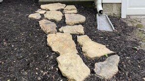 A front door with a stone pathway leading to a porch. - 6BR Downtown | Side-by-Side Townhomes | 2 Garages (Indianapolis)