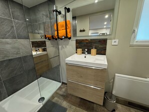 Shower, hair dryer, towels, toilet paper