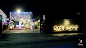 A nighttime view of Yash Lawn with illuminated decorations and a signboard. - Jb innovations (Lucknow)