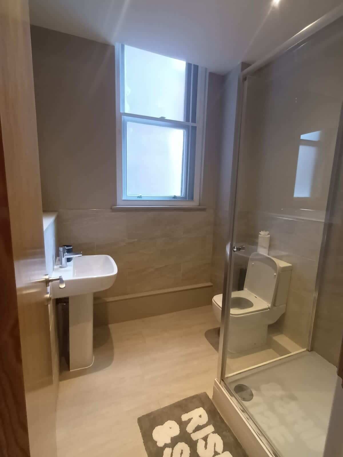 A bathroom with a sink, toilet, and shower.