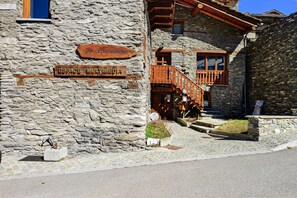 A stone building with wooden signage indicating 'Pa Pastoral' and 'ESPACE MULTIMEDIA.' - Apartment 'Les Gentianes' with Mountain View and Wi-Fi (Val-Cenis)