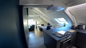 Un apartamento moderno estilo loft con cocina, comedor y sala de estar.