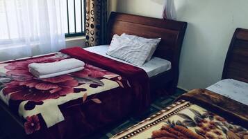 Desk, laptop workspace, bed sheets