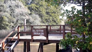 Una terraza de madera con un letrero que dice 'EL SITIO DORADO'.
