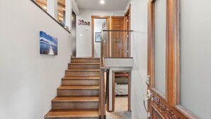A wooden staircase leading to a bedroom with a bed and a door. - Edgewater Escape in Dollar Point Tahoe City (Tahoe City)