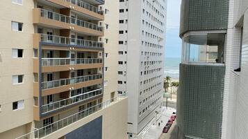 A multi-story hotel with balconies, a beach view, and a prominent 'Acqua Mare' sign.