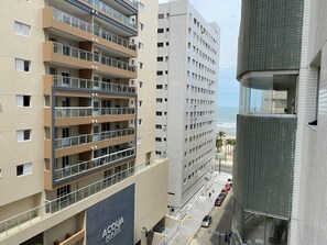 A multi-story hotel with balconies, a beach view, and a prominent 'Acqua Mare' sign.
