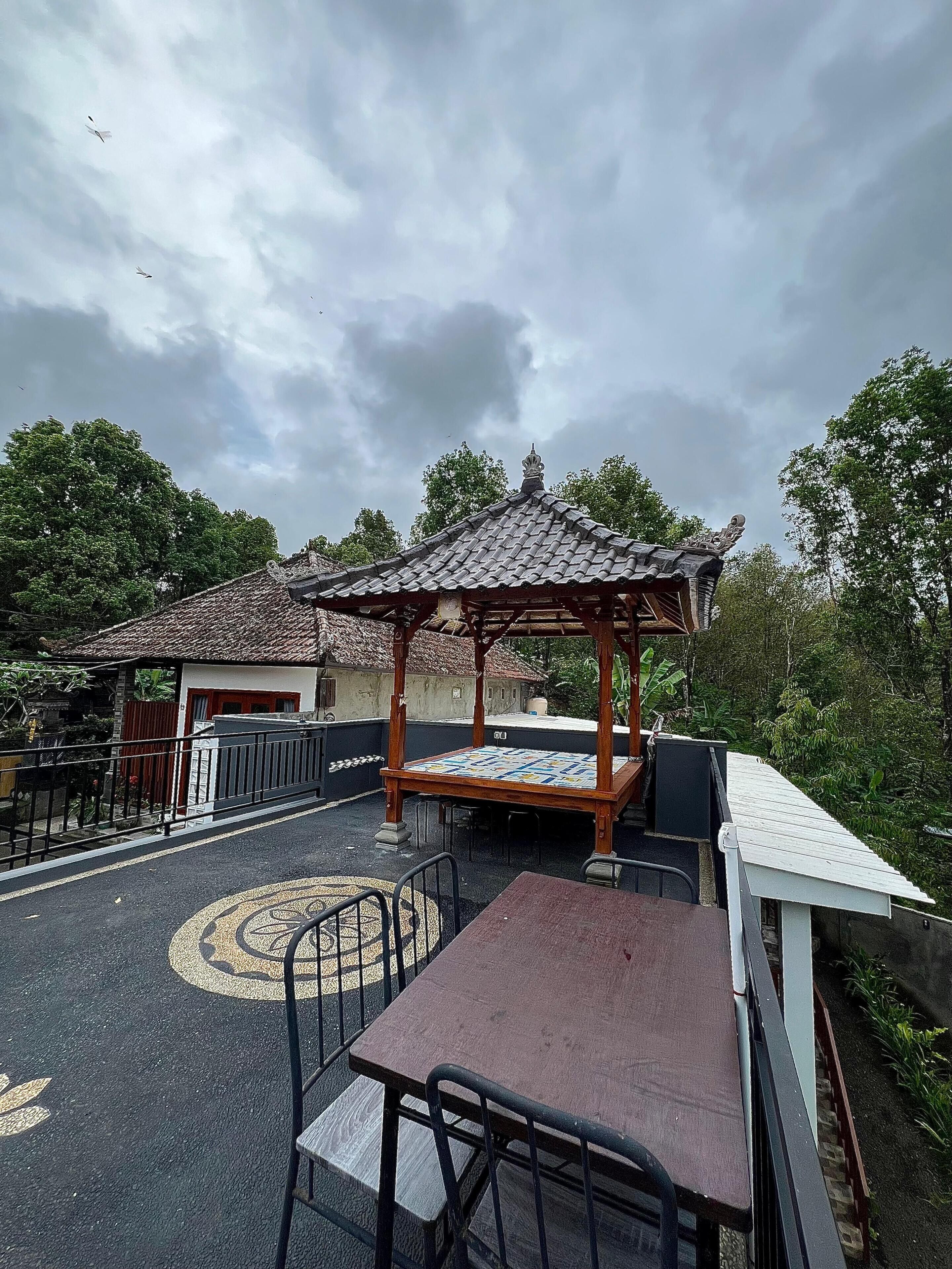 An outdoor seating area with a gazebo, tables, and chairs.