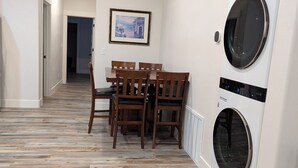 A modern kitchen with white cabinets, a stainless steel range hood, and a built-in oven. - Charming 2-bedroom apartment with WiFi , AC and Heating in serene Enterprise (Enterprise)