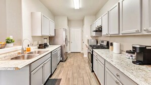 A modern kitchen with white cabinets, stainless steel appliances, and granite countertops. - Fun Family Friendly Home Great Location in Houston 3BDR 2.5 Bath (Houston)