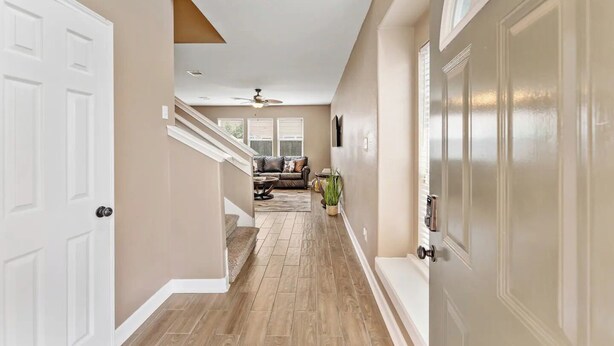 A hallway with a staircase leading to a living area. - Fun Family Friendly Home Great Location in Houston 3BDR 2.5 Bath (Houston)