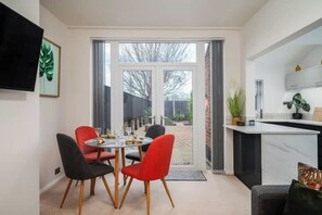 Enjoy meals in the dining area with a round table and four chairs, or cook in the kitchen with a countertop and cabinet.