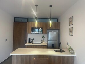 Fridge, microwave, stovetop, coffee/tea maker