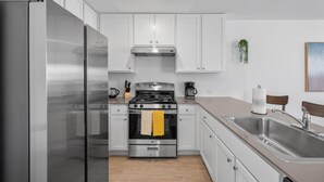 Coffee/tea maker, fridge, electric kettle, cookware/dishes/utensils