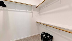 A closet with wooden rods and a black laundry basket. - Spacious Modern 5 beds House in Troy (Troy)