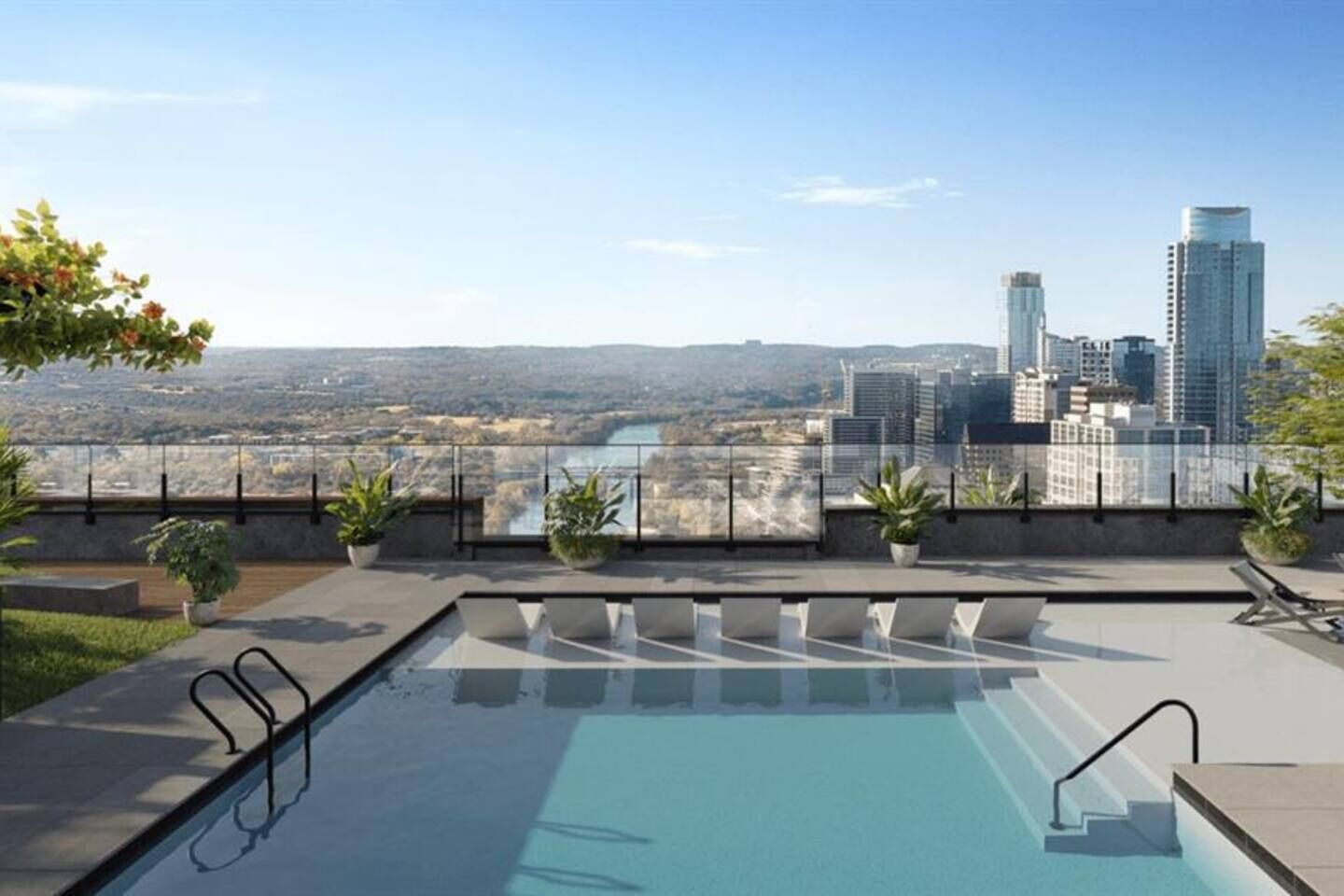 A rooftop pool with a city view, potted plants, and a glass railing.