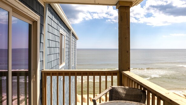 A wooden deck with a view of the ocean.