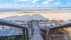 A wooden staircase leading to a beach with a clear sky. - NEW LISTING - Oceanfront Condo ~ Excellent Location (Saint Augustine)