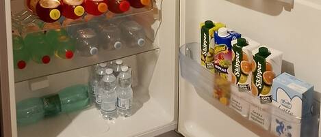 A refrigerator stocked with various food items and beverages.
