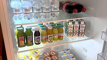 A refrigerator stocked with various beverages and dairy products.