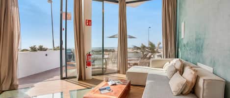 Deluxe Duplex, Ocean View | Living area | Flat-screen TV