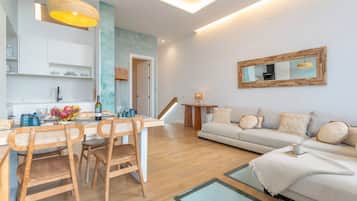 Deluxe Duplex, Ocean View | Living area | Flat-screen TV