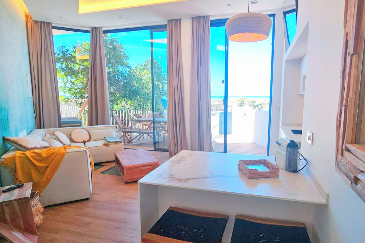 Deluxe Duplex, 2 Bedrooms, Ocean View | Living area | Flat-screen TV