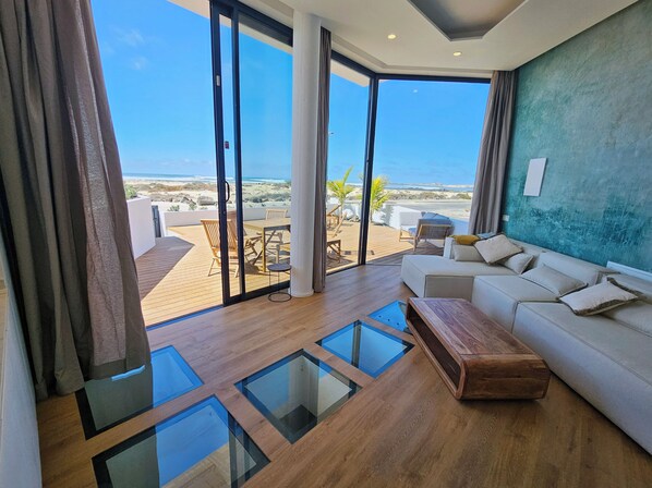 Deluxe Duplex, Ocean View | Living area | Flat-screen TV