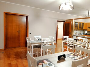 Enjoy meals in this dining area with a table for four and a view into the adjacent kitchen.
