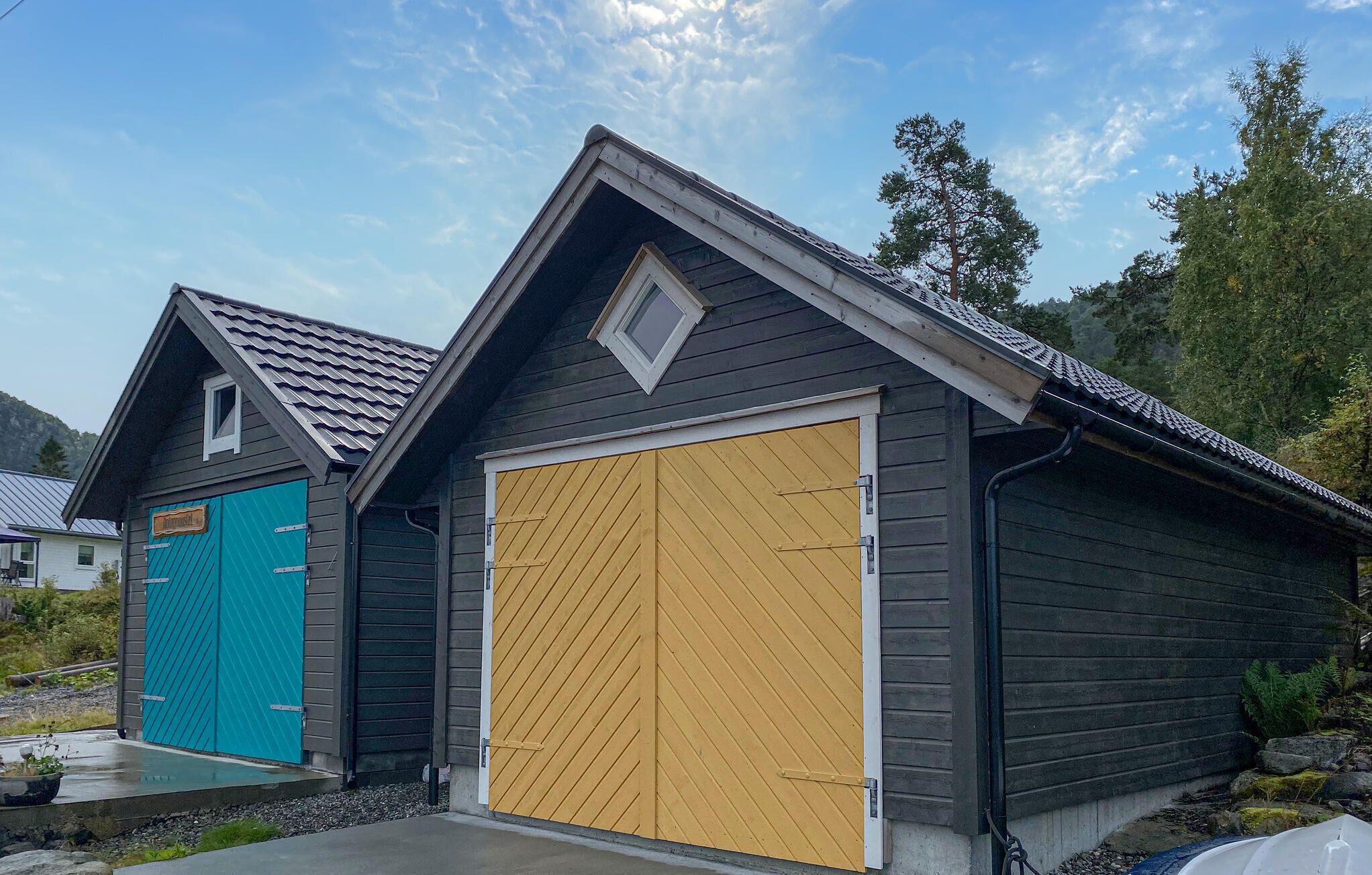 A two-car garage with a dark exterior and a yellow garage door.